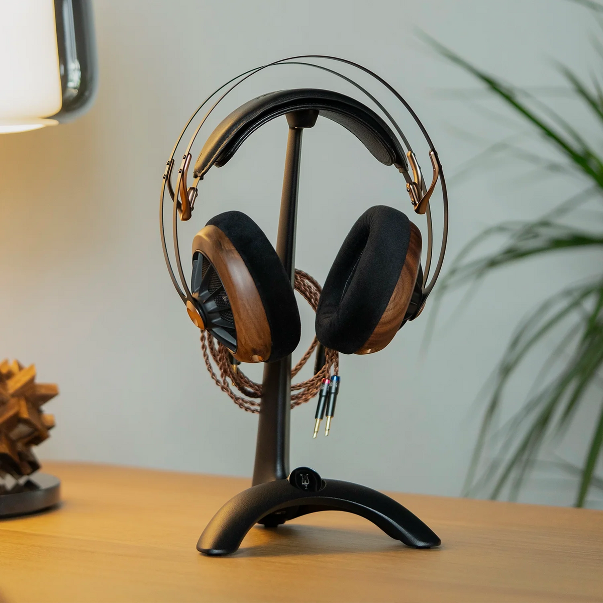 Meze Audio Manta Headphone Stand, holding a Meze headphone on a desk
