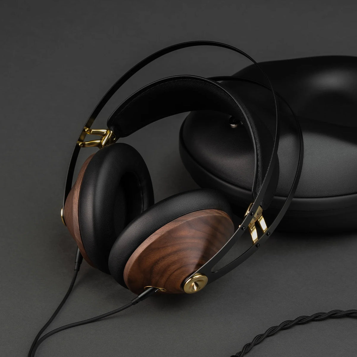 Meze Audio 99 CLASSICS (2nd Gen), lying beside its case with the cable