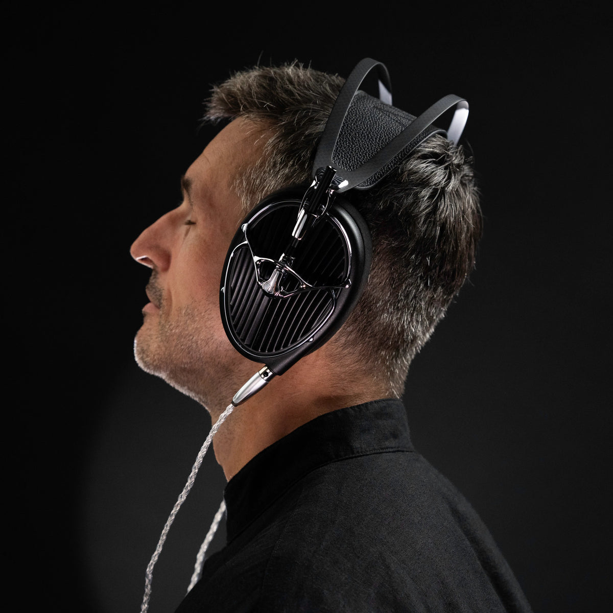 Meze Audio ARTA, worn by a listener, in profile