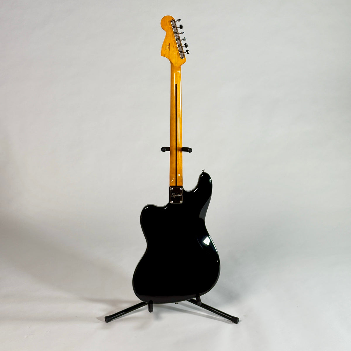 Used Squier Bass VI in black, full length, back