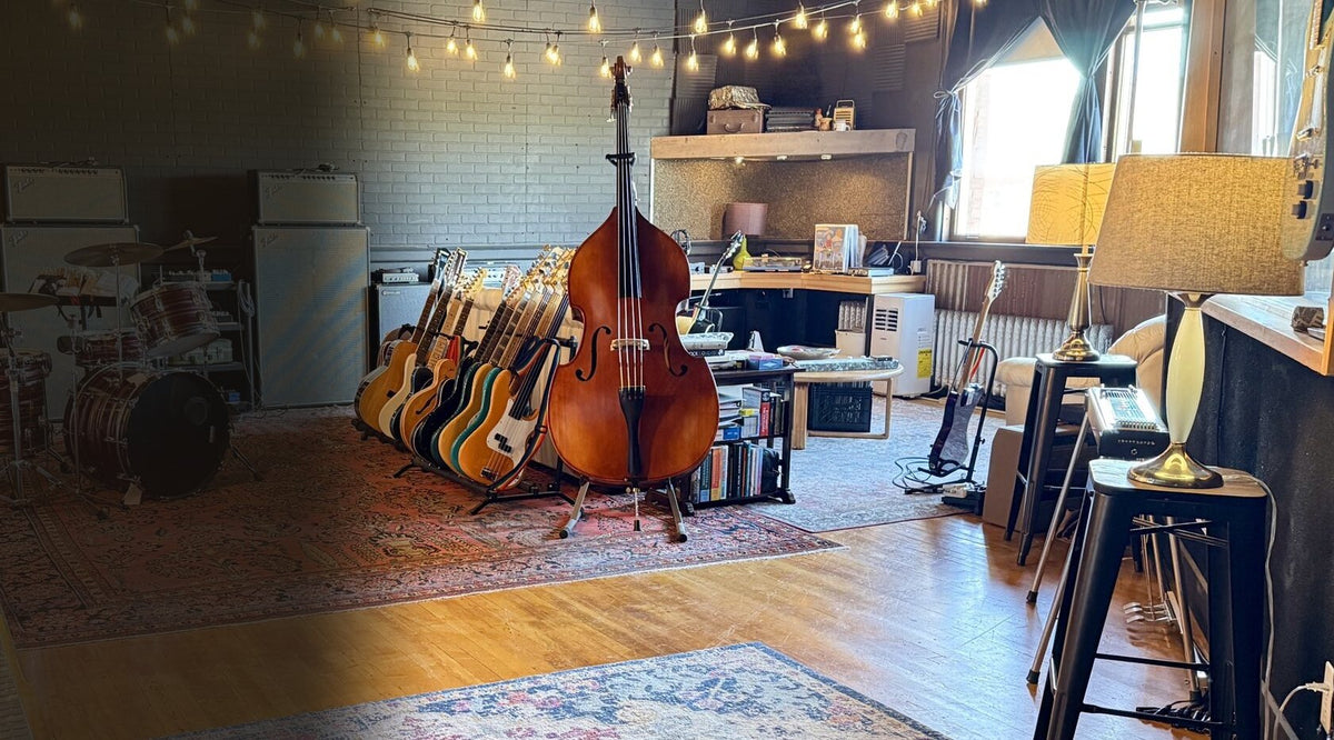 The listening room at Free River Studios: the guitar rack, an upright bass and a pedal steel by the window