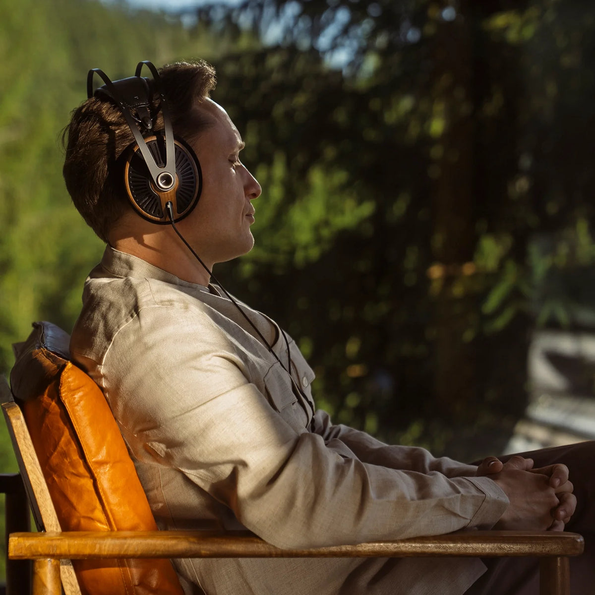 Meze Audio 105 SILVA, worn by a listener sitting outdoors