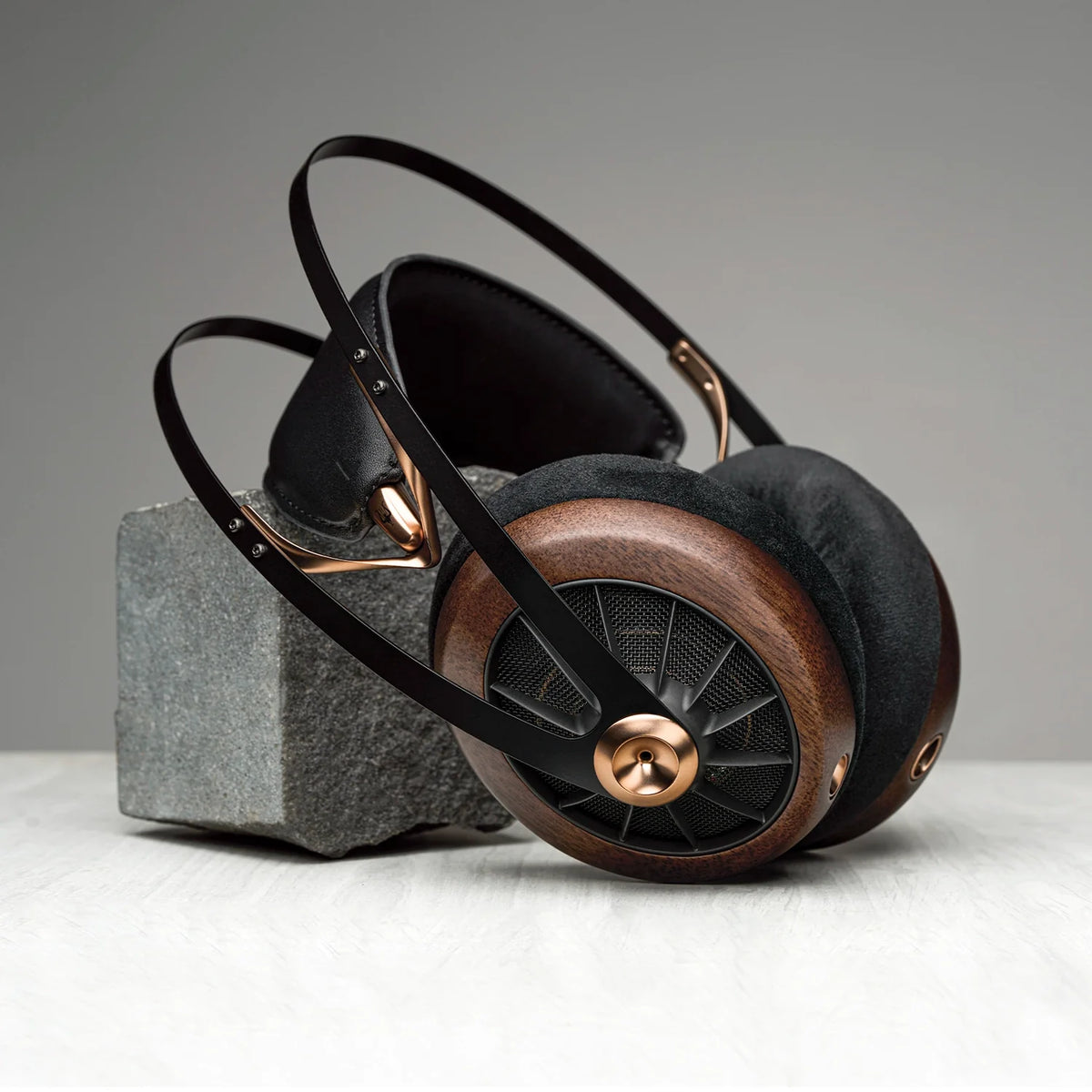 Meze Audio 109 PRO, resting against a stone block