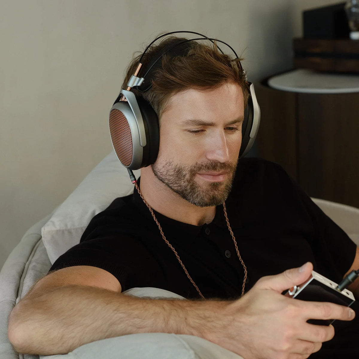 Meze Audio POET, worn by a listener with a portable player