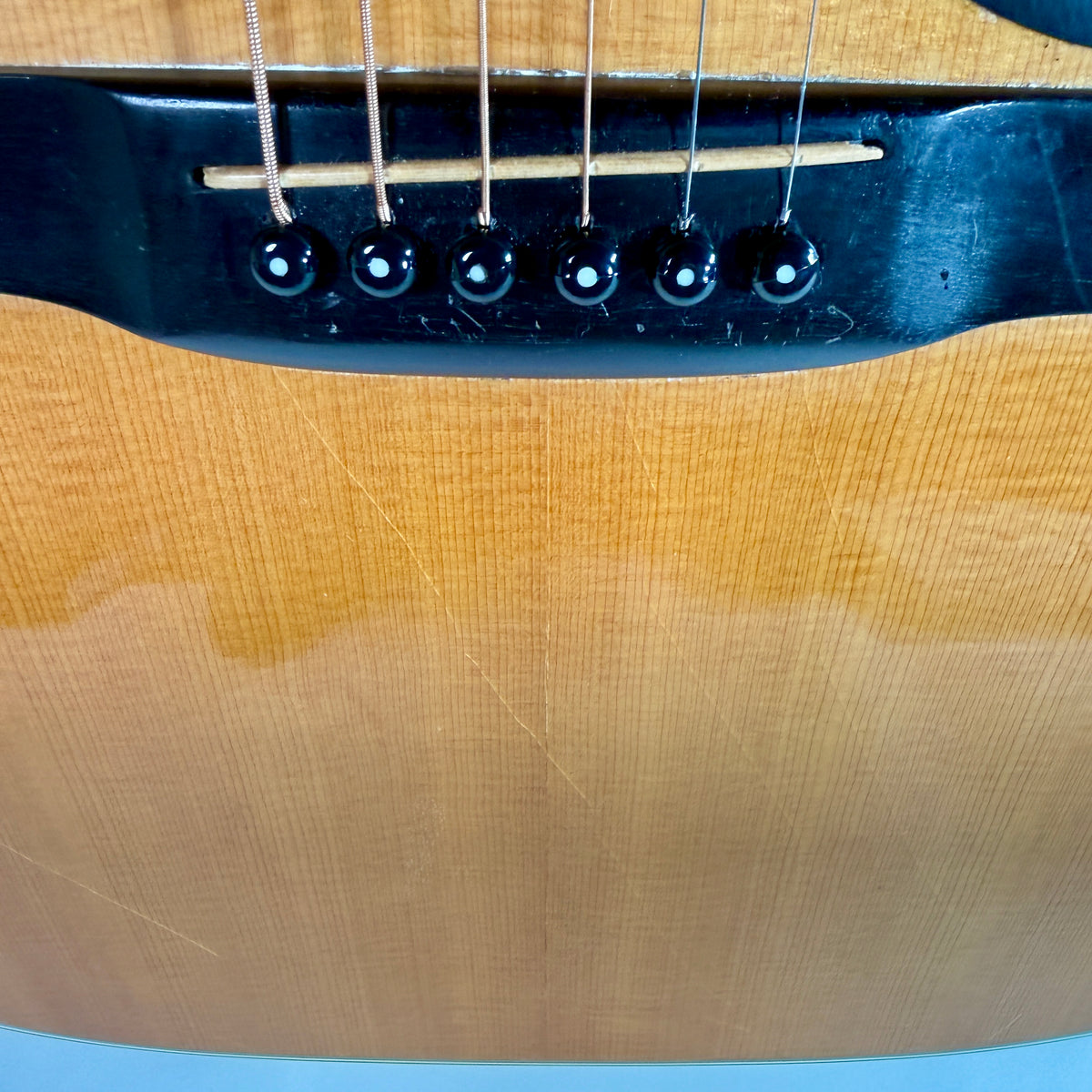 Used 1976 Martin D-28, close up of the bridge and pick wear on the top