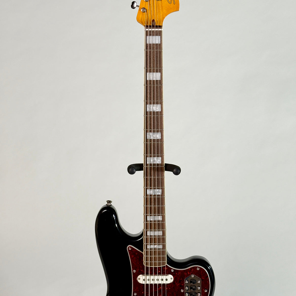 Used Squier Bass VI in black, front of the neck