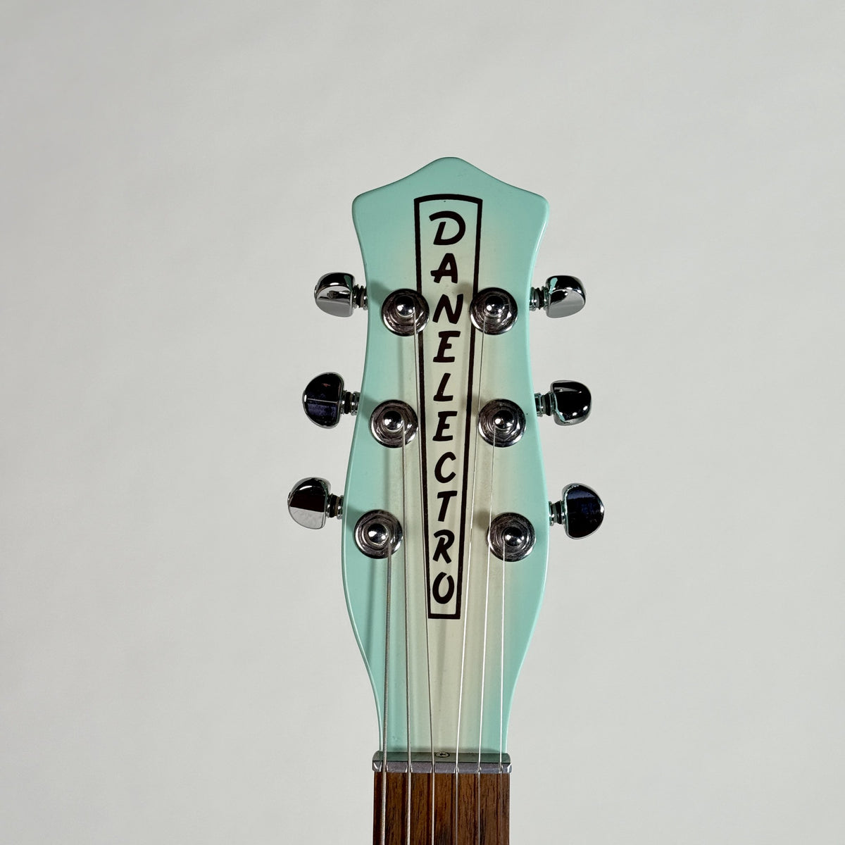 Used Danelectro '56 U-2 reissue in Aqua Burst, front of the headstock