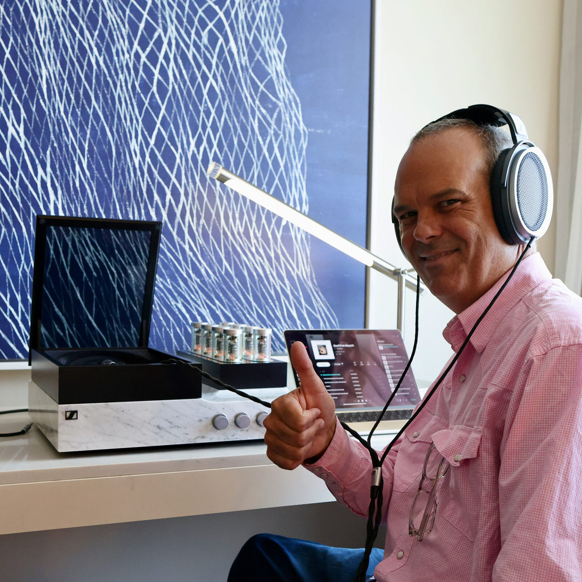 Jamey Warren giving a thumbs up while listening on headphones