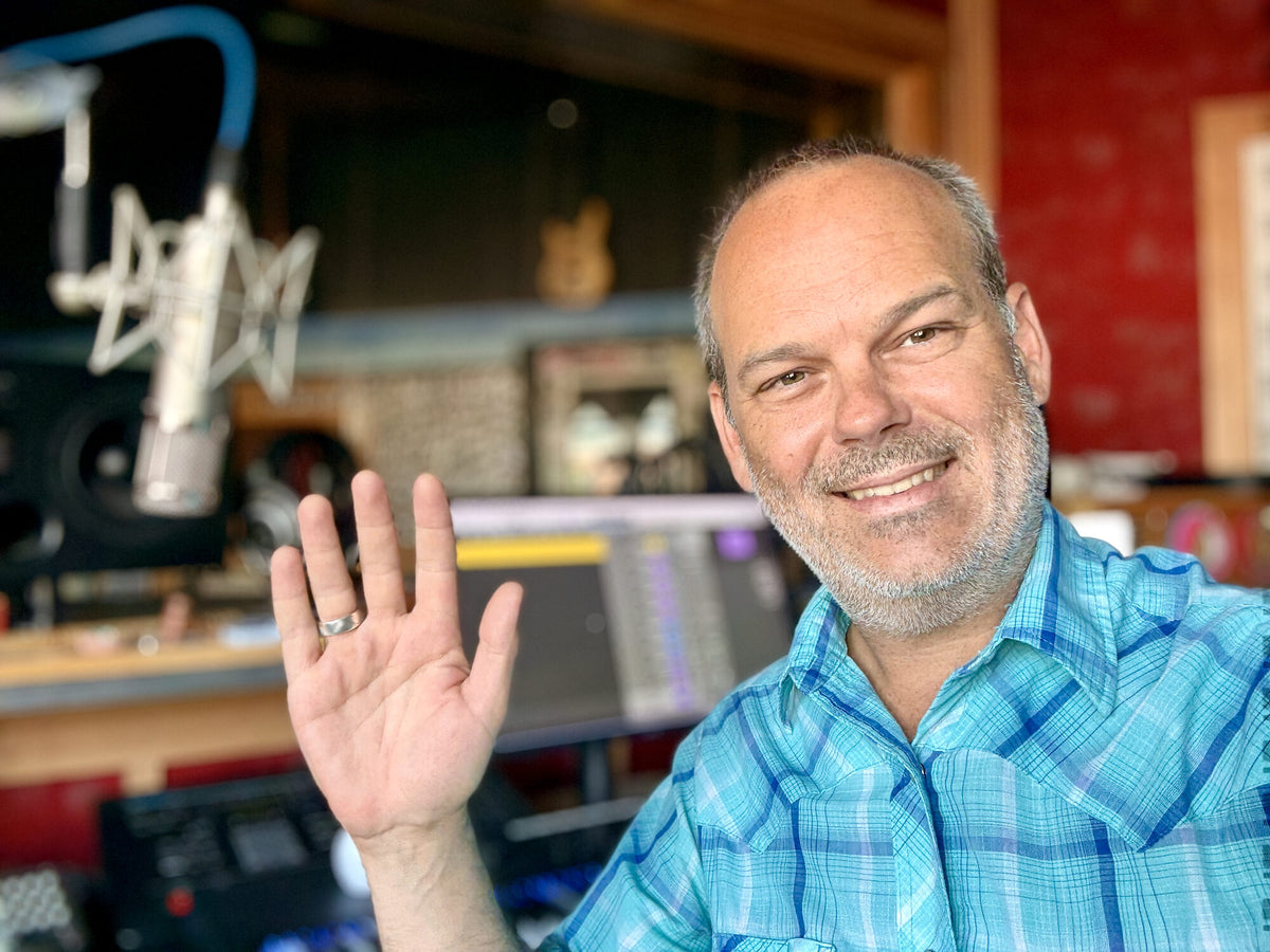 Jamey Warren waving hello in a recording studio