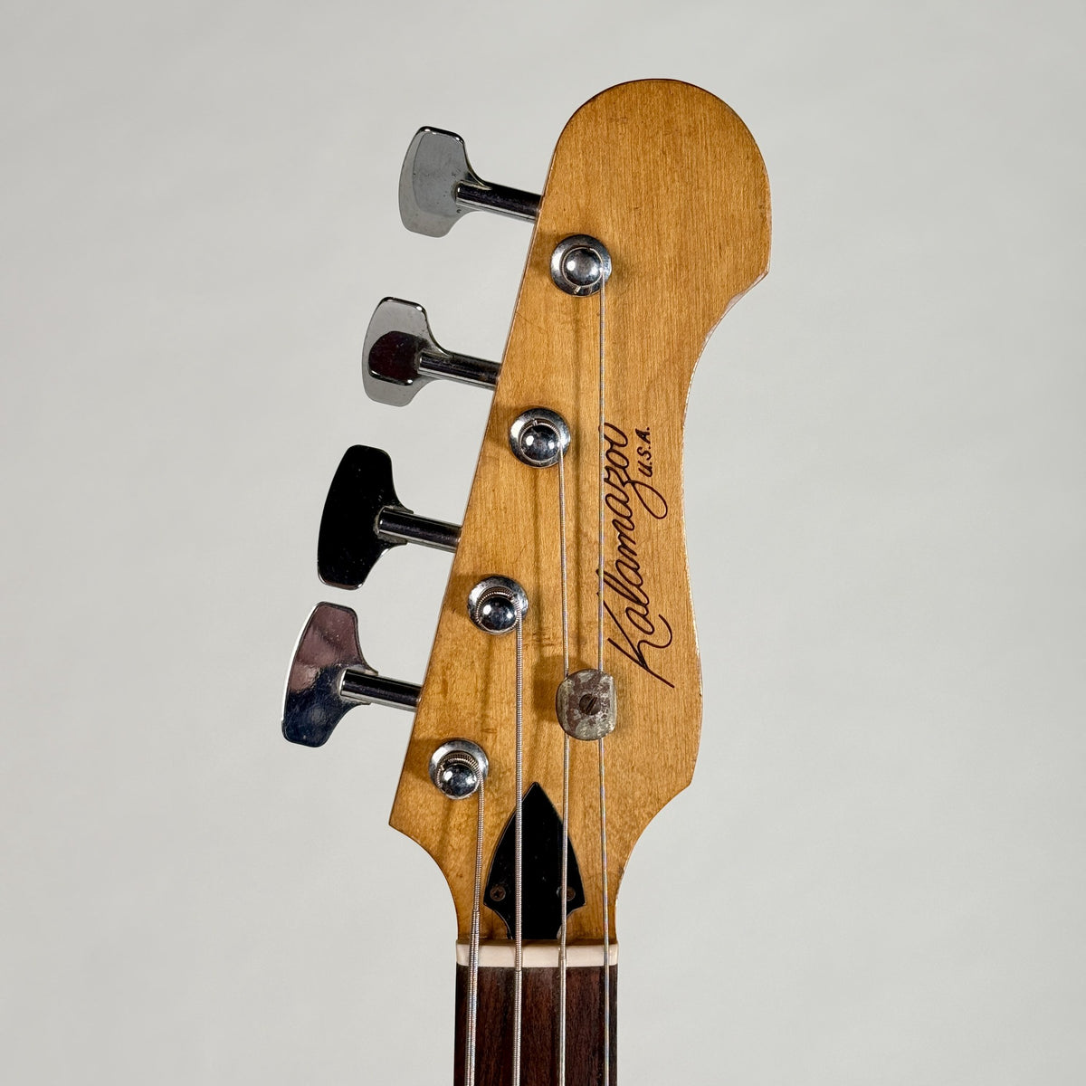 Used Kalamazoo bass in white, front of the headstock