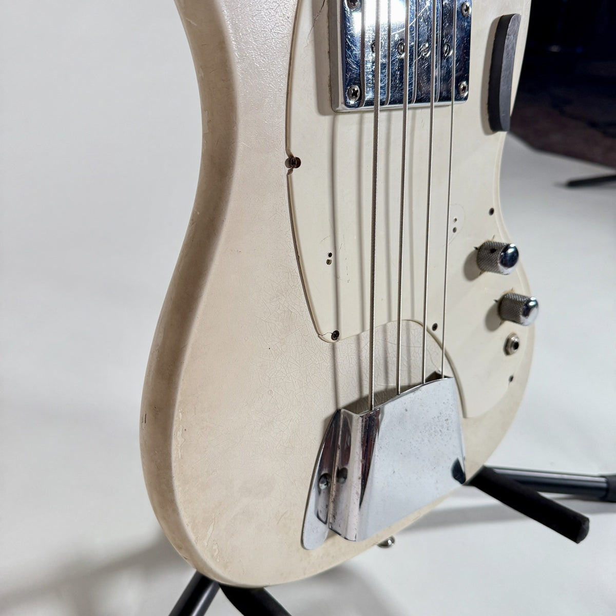 Used Kalamazoo bass in white, angled view of the body and bridge cover