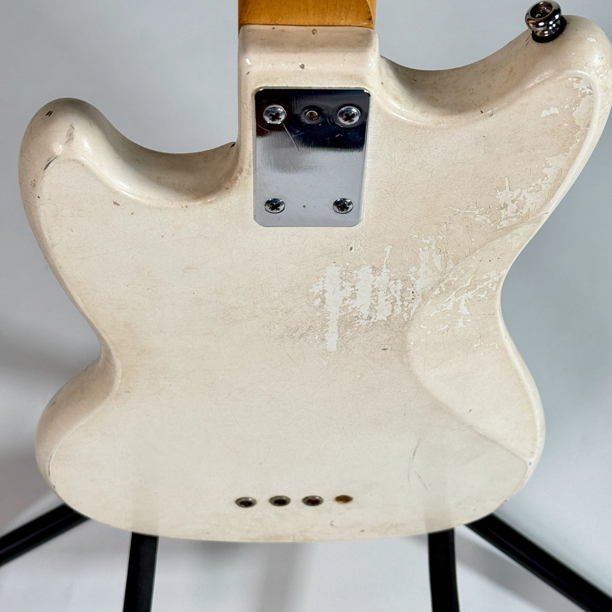 Used Kalamazoo bass in white, close up of the neck plate and wear on the back