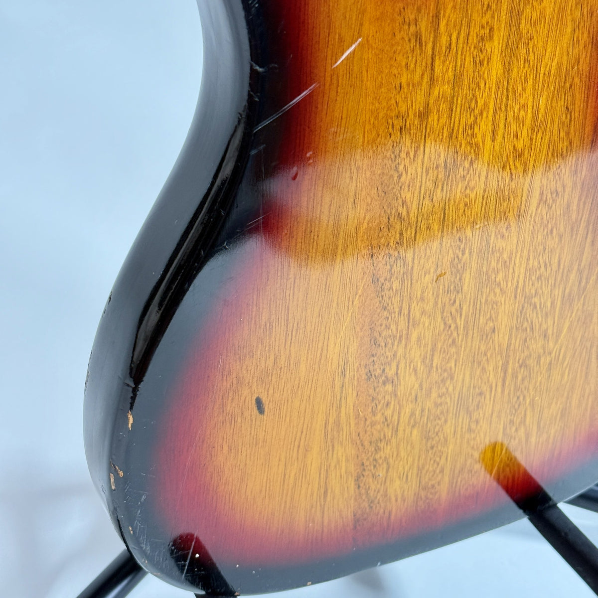 Used unbranded P-bass style bass in sunburst, close up of scratches on the back of the body