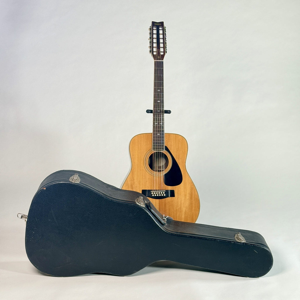 Used Yamaha FG-512 12-string dreadnought and its hardshell case, from a lower angle